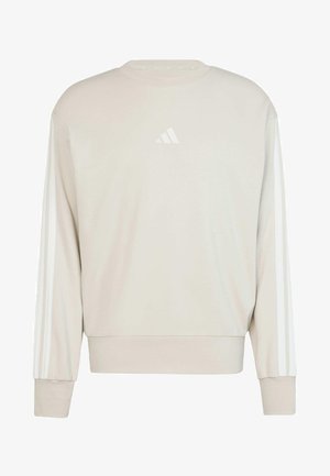 Lys beige sweatshirt med lange ærmer, rund halsudskæring og hvid tre-stribe design langs begge ærmer. Har et lille hvidt logo på brystet.