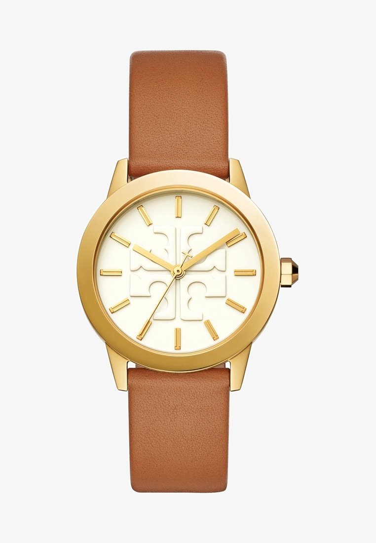 Montre ronde en or avec un cadran blanc, des marqueurs d'heure dorés et des aiguilles, et un bracelet en cuir marron affichant un motif croix sur le cadran.