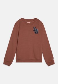 Braun Sweatshirt aus weichem Stoff, mit rundem Halsausschnitt, langen Ärmeln und blauem gesticktem Logo auf der Brust. Mit gerippten Bündchen und Saum.