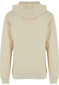 Felpa con cappuccio beige realizzata in morbido misto cotone, caratterizzata da un design semplice, polsi a coste e schiena senza cuciture. Senza chiusura frontale né tasche.