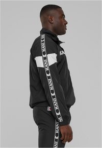 Karl Kani RETROTAPE TRACKJACKET Summer jacket black Zalando