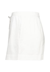 White linen shorts with an elastic waistband, side pockets, and a relaxed fit. Features a clean hem and minimal detail.