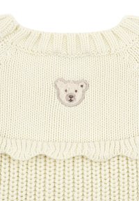 Sweter dziany w kolorze off-white z prążkowanym dekoltem i ozdobnym falbanym dołem. Na plecach znajduje się haftowany wzór niedźwiedzia polarnego.