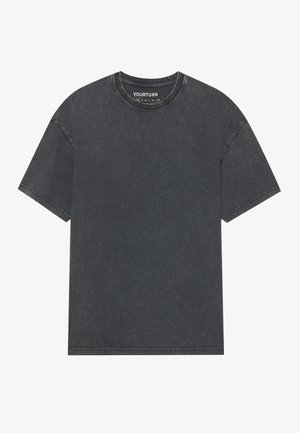Dark gray oversized T-shirt with a round neckline and short sleeves. Features visible stitching and a soft, textured fabric.