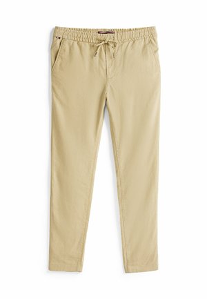 Beige chinos ar elastīgu jostasvietu un saiti, ar sānu kabatām un gludu, vieglu audumu.