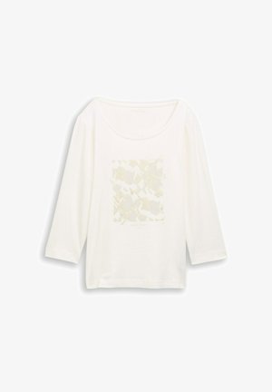 Bela dolga majica z dolgimi rokavi in okroglim izrezom, z diskretnim bež abstraktnim vzorcem v središču spredaj.