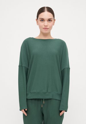 Green long-sleeve top with a wide neckline and dropped shoulder seams. Made of soft fabric, featuring a relaxed fit and ribbed hem.