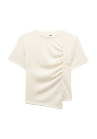 Kortærmet, cremefarvet t-shirt med struktureret stof. Har sidelivning og en asymmetrisk kant for unikt design.