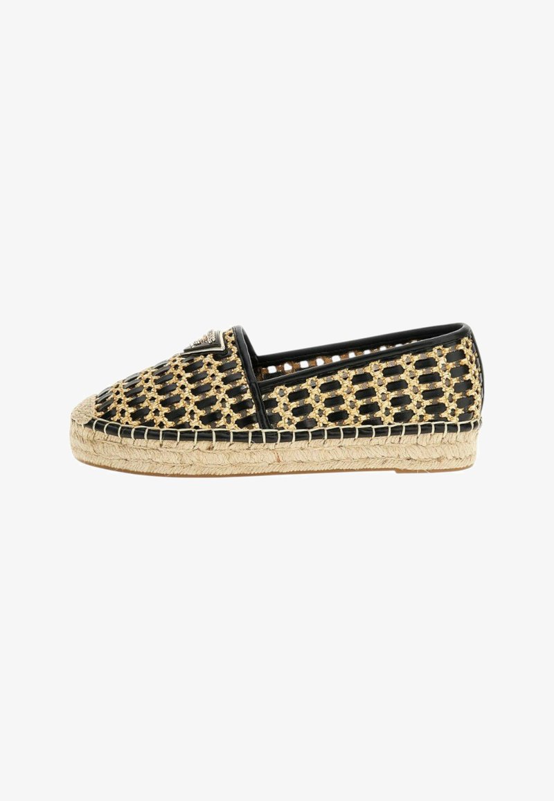 Espadrille-schoen met een geweven zwarte en gouden bovenkant, juten touwzool en ronde neus. Heeft een decoratieve zwarte accent aan de voorkant.