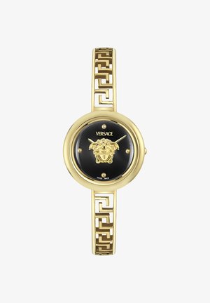 Zlatni Versace ručni sat s crnim brojčanikom, simbolom glave Meduze u sredini, zlatnom narukvicom s grčkim ključem i minimalnim oznakama za sate.