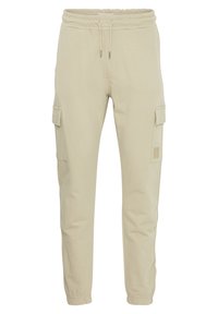 Beige katoenen cargobroek met elastische tailleband, verstelbare trekkoord, zijzakken en taps toelopend ontwerp.
