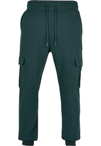 Pantaloni joggers de culoare verde închis, realizati dintr-un amestec de bumbac. Au un tiv elastic la talie cu șnururi și buzunare laterale pentru cargo. Manșete la glezne.