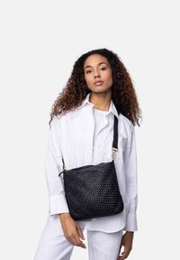 Borsa a tracolla in pelle intrecciata nera con forma rettangolare, dotata di chiusura con cerniera e tracolla regolabile. Superficie testurizzata con una leggera lucentezza.