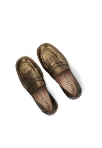 Bronze leather loafers with a textured finish, featuring a fringe accent and a rubber sole. Inside shows brand logo "HISPAÑITAS."