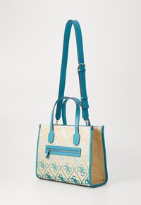 Blue and beige woven handbag with a structured shape, featuring leather handles, a zippered front pocket, and floral patterns.