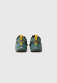 Sport shoes with a teal mesh upper, yellow accents, and black branding. Textured outsole and pull tabs for easy wear.
