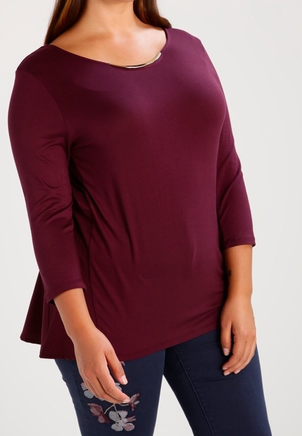 Burgunderfarbene Peplum-Bluse mit Dreiviertelärmeln, featuring einem runden Ausschnitt, verziert mit einem metallischen Akzent und floraler Stickerei an der Seite.