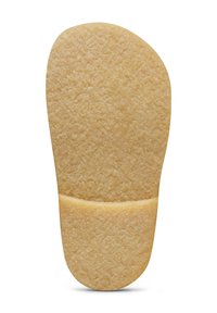 Suola di scarpa in gomma crepe con superficie testurizzata, divisa da una linea orizzontale, mostrata su uno sfondo bianco.