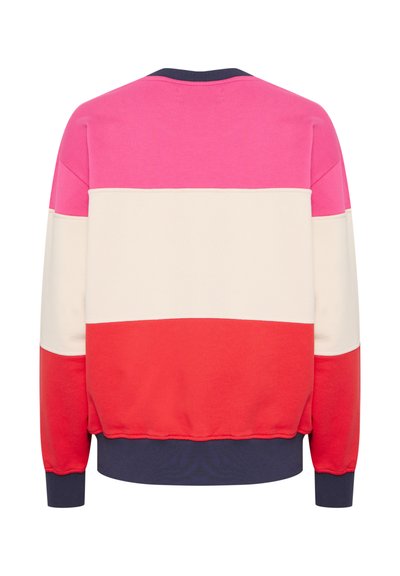 Krāsainais džemperis ar rozā, krēmkrāsas un sarkanām daļām, ar ribotām tumši zila krāsa apkakli un piedurknēm. Mīksta kokvilnas auduma sastāvs ar brīvu piegriezumu.