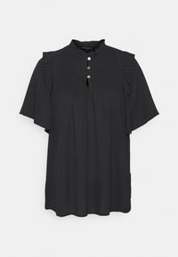 Blouse noire à manches courtes avec détails en volants plissés sur les épaules, trois boutons près de l'encolure ronde et coupe ample.