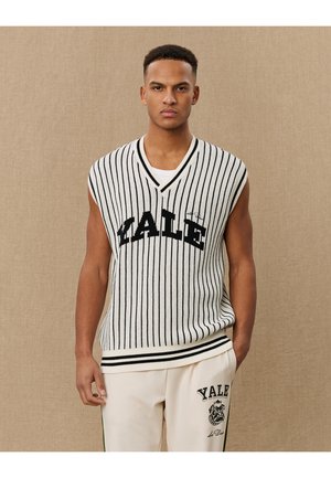 Sleeveless, white and black striped knit vest featuring "YALE" in bold letters, with a v-neck design and ribbed trim.