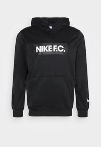 Schwarzer Hoodie aus glattem Material mit einer Fronttasche, einem großen weißen "NIKE F.C."-Logo und einem weißen Nike-Swoosh am Ärmel.