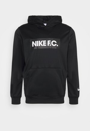Hoodie noir en tissu lisse avec une poche avant, un grand logo "NIKE F.C." blanc et un swoosh Nike blanc sur la manche.