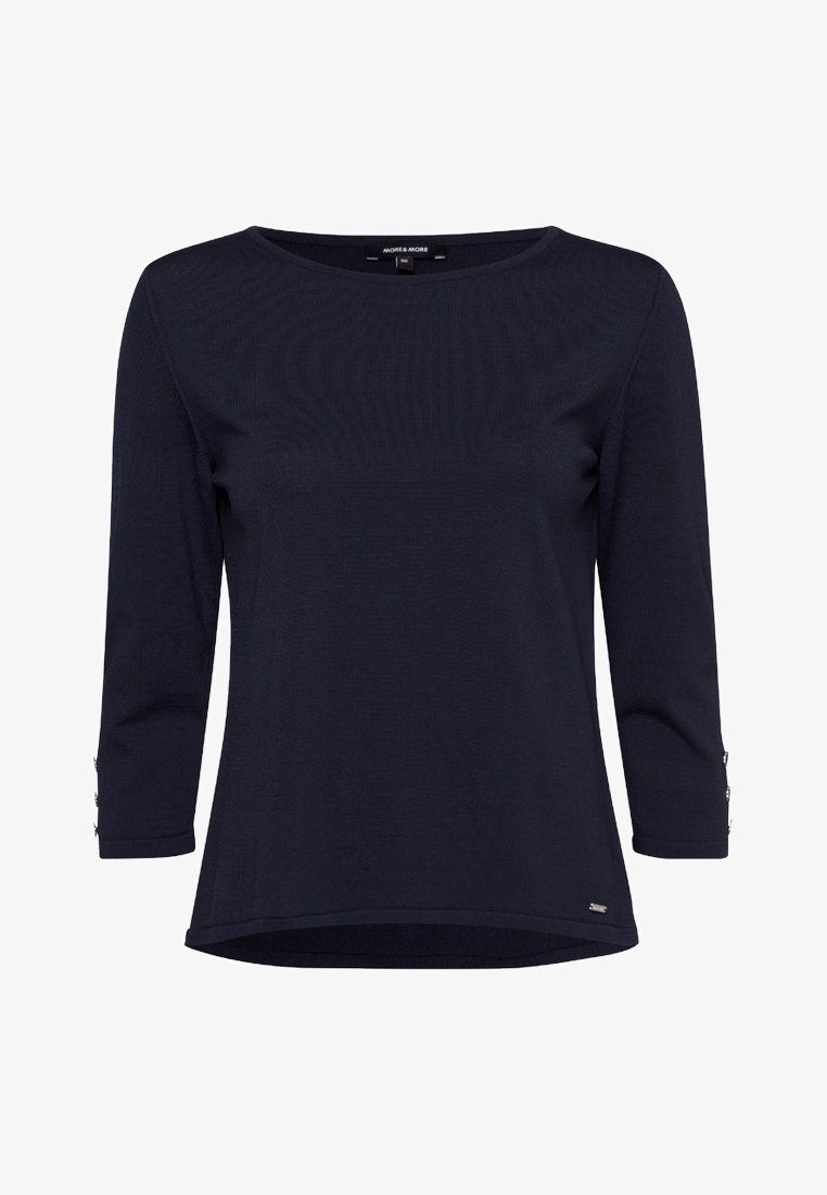 Chemise bleu marine à manches longues avec encolure ronde et détails de boutons aux poignets, ourlet légèrement arrondi et petit logo en métal sur le devant.
