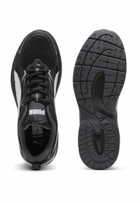 Black athletic shoes with mesh and synthetic upper, featuring white accents, round toe, rubber outsole with a textured grip pattern.