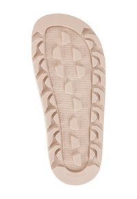 Light beige shoe sole made of rubber, featuring a textured surface with tread patterns and grooves for traction. "MADE IN ITALY" embossed.