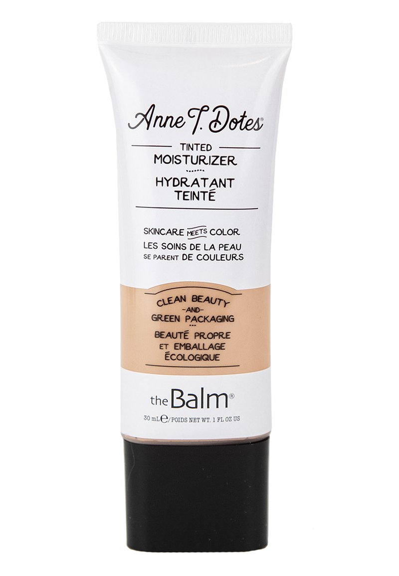 Crema idratante colorata in un tubo bianco a compressione con base marrone. Cappuccio nero, testo stampato in vari caratteri che evidenziano gli aspetti ecologici.