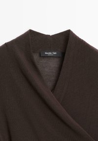Dark brown ribbed knit garment with a folded V-neck collar and a black Massimo Dutti label sewn inside.