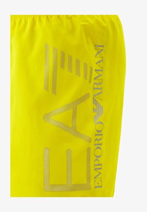 Bright yellow fabric with large dotted Emporio Armani logo and text in silver-gray on the side.
