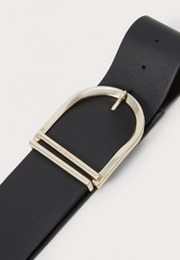 Black leather belt featuring a large gold-tone metal buckle with a rectangular shape and two horizontal bars for secure fastening.