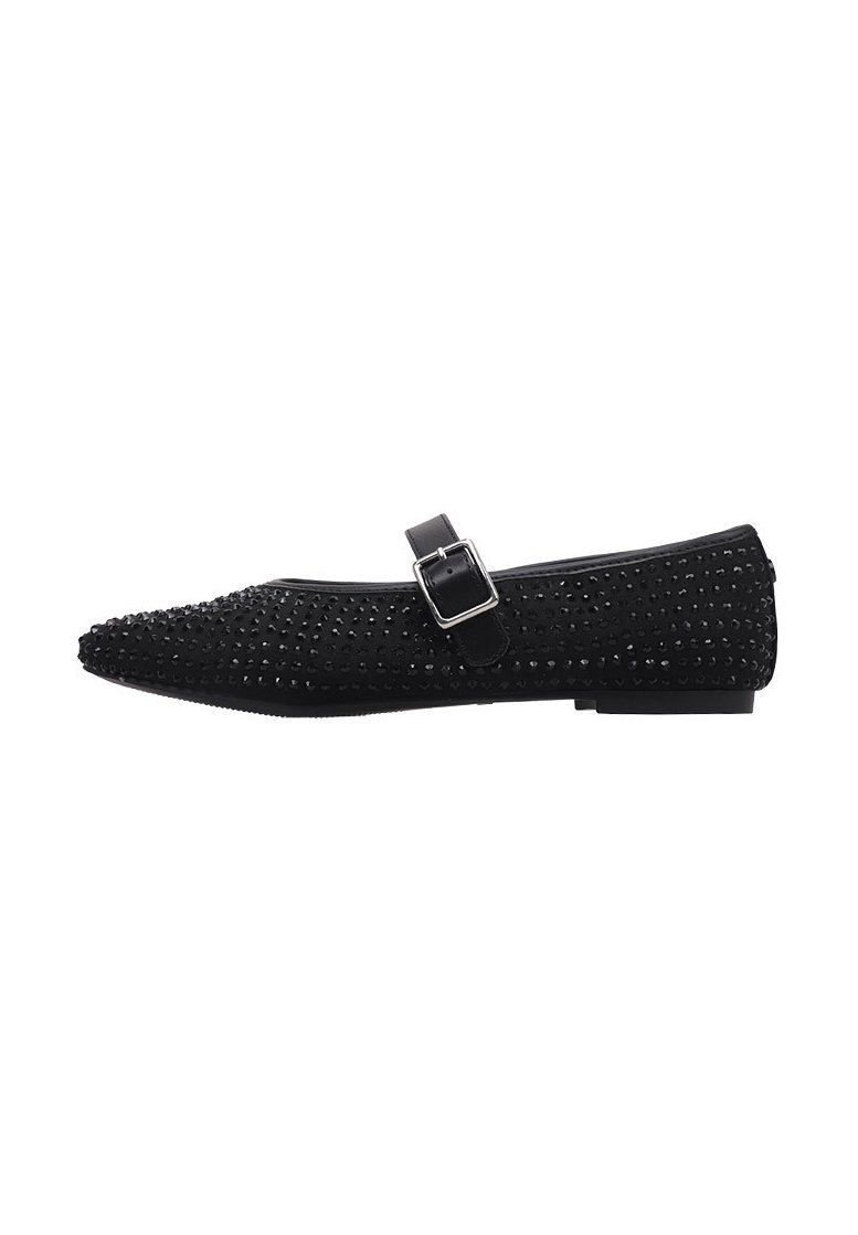 Black flat shoe with pointed toe, adorned with small studs. Features a strap with a buckle and a textured surface. Low-profile sole.