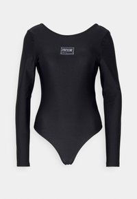 Svart långärmad bodysuit gjord av ett mjukt, elastiskt tyg. Har en rund halsringning och en liten märkesetikett på framsidan.