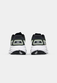 Black running shoes featuring a breathable mesh upper, white midsole, and neon green accents on the heel and sides. Textured rubber outsole.