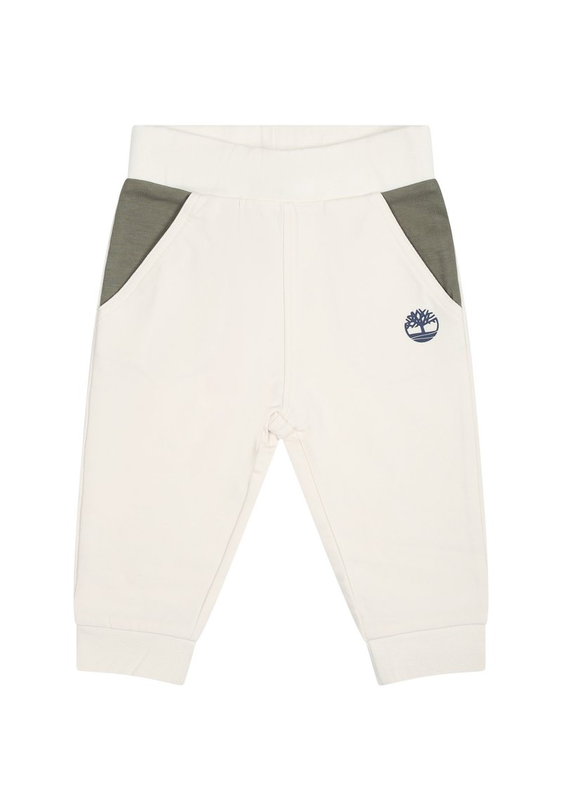 Crème-kleurige sweatpants met groene zijzakken, elastische tailleband en geborduurd logo. Zacht materiaal met een gladde textuur.