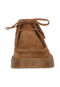 Brown suede lace-up shoes with a rounded toe, featuring a stitched design and a flexible rubber sole. Laces match the shoe color.