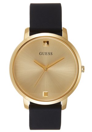 Goudkleurig Guess polshorloge met minimalistische wijzerplaat, zwarte band en zonder cijfers, toont de tijd 10:10:36.