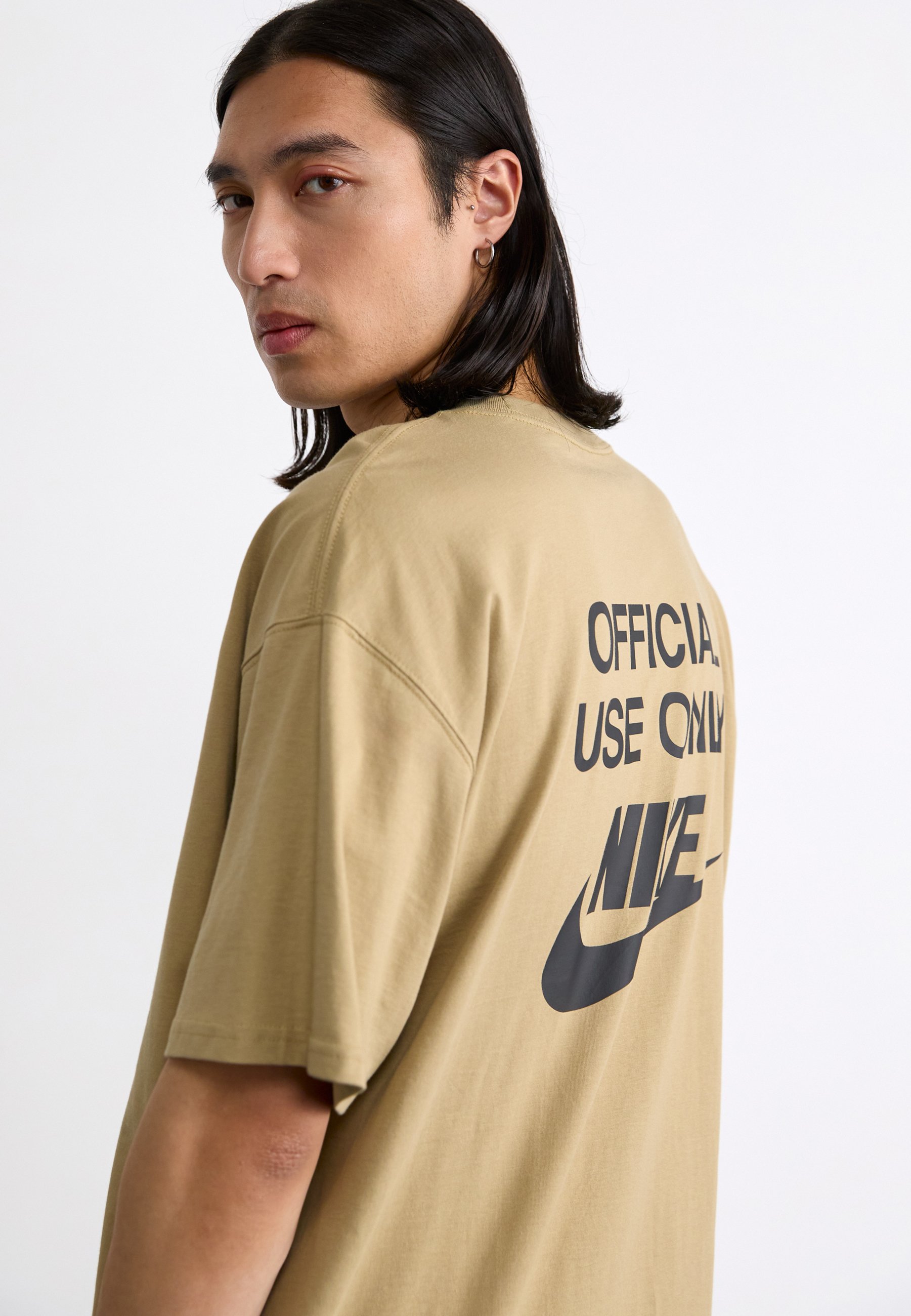 tan and black nike shirt