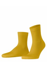 Gelbe Baumwollsocken mit gerippten Bündchen und nahtlosen Zehen. Die Socken haben eine glatte Textur und eine taillierte Form, geeignet für den Freizeitgebrauch.