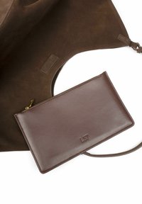 Brown leather pouch with a smooth texture and zip closure, featuring embossed logo. Inside is a soft, dark brown suede lining.