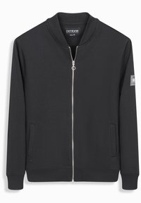 Chaqueta negra de cremallera con tejido suave, con cuello y puños acanalados. Cuenta con bolsillos laterales y un parche con el logo en la manga. Talla mediana.