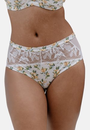 Woman wearing floral lingerie set with a sheer white lace panel on high-waisted panties and matching bra top against white background.