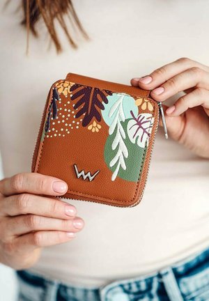 Brown leather wallet with floral embossed design in shades of green, purple, and beige. Features a silver logo and zip closure.