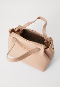 Bolsa de mão de couro rosa claro com superfície texturizada, detalhes em dourado e duas alças. A abertura superior com fecho de correr revela compartimentos interiores.