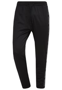 Svarta joggerbyxor i mjukt tyg, med en avsmalnande design, elastisk midja med snöre och sidologotyptryck.