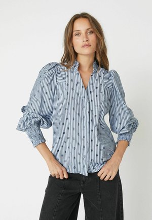 Striped blouse in light blue with navy patterns, featuring puffed sleeves, a collar, and gathered cuffs. Soft fabric, relaxed fit.