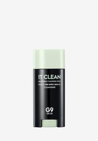 Bâton de nettoyage des points noirs dans un tube noir avec des accents verts. L'étiquette indique "IT CLEAN G9 SKIN". Texture lisse, forme cylindrique.